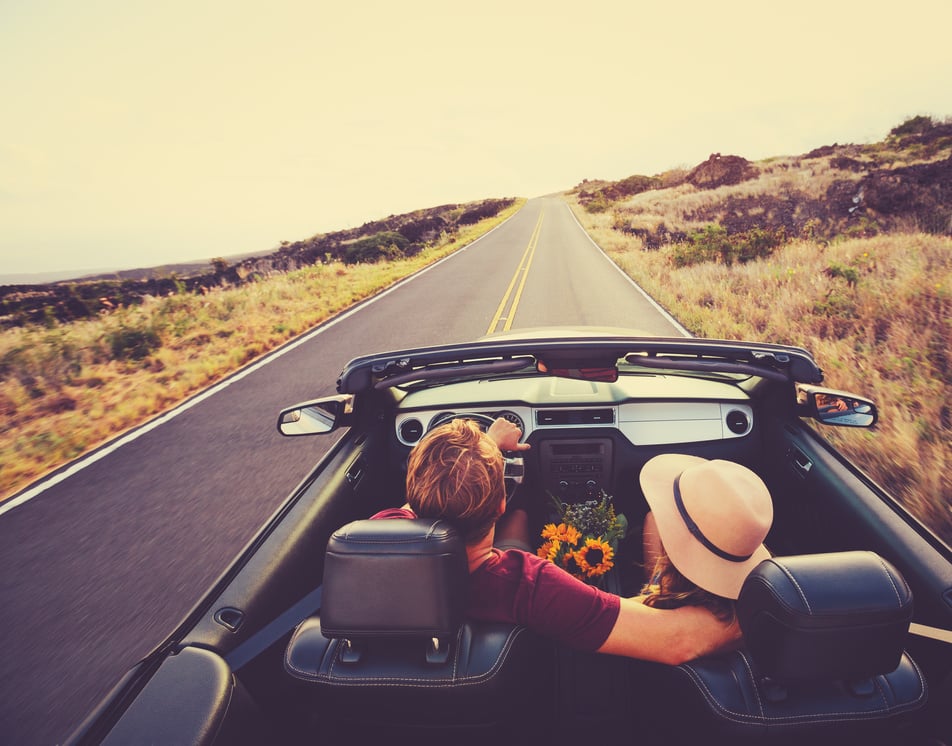 Happy Couple Driving in Convertible